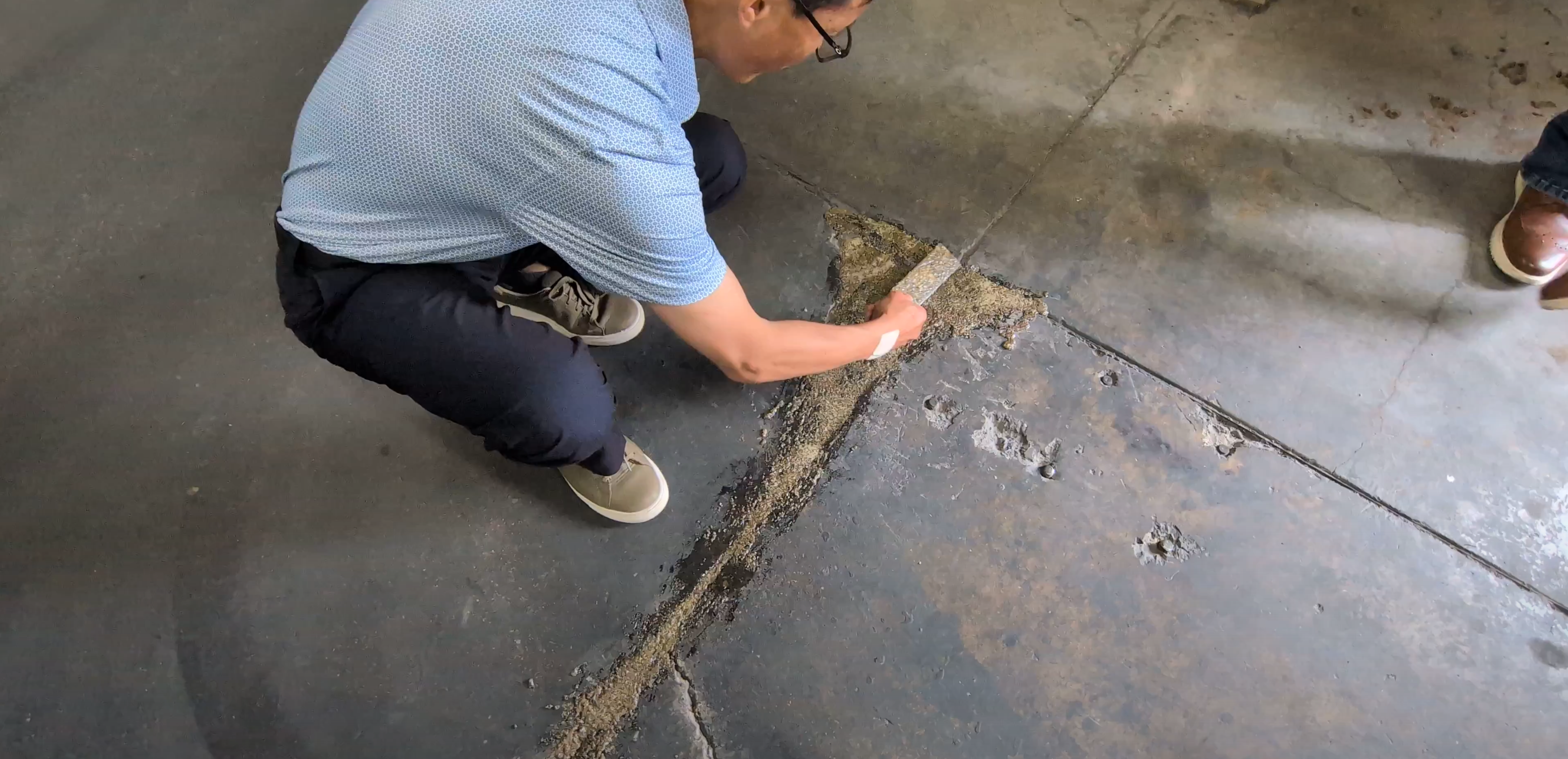 Photo of concrete floor crack being repaired with FasTrac Crackweld Pro.
